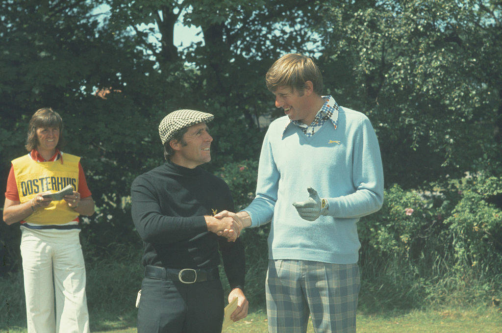 Paul Stevens caddying for Peter Oosterhuis who shakes hands with Gary Player